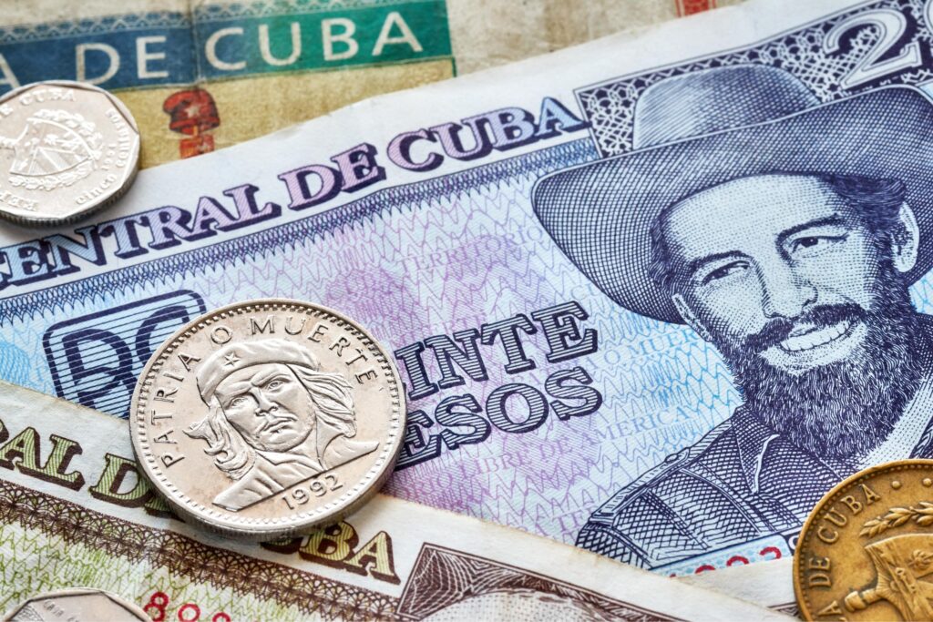 Close-up of Cuban peso banknotes and coins with Fidel Castro and Che Guevara
