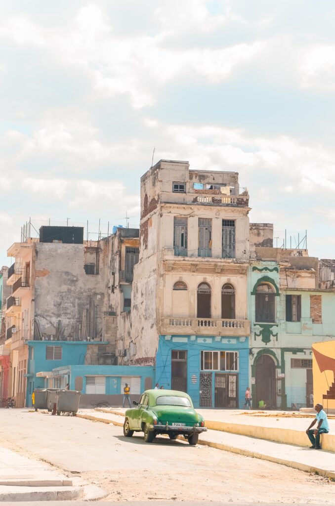 Old buildings and a vintage car in Havana, Cuba